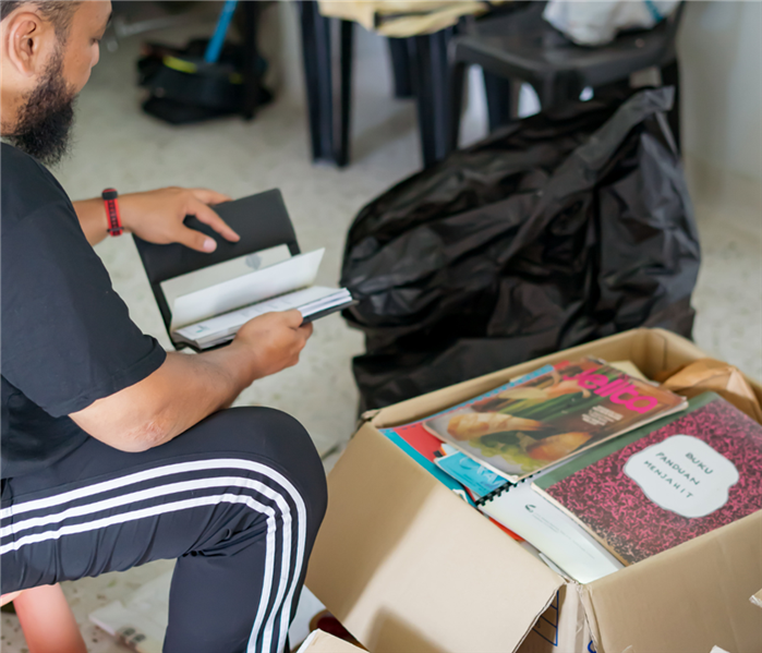 Person sorting through a box of belongings